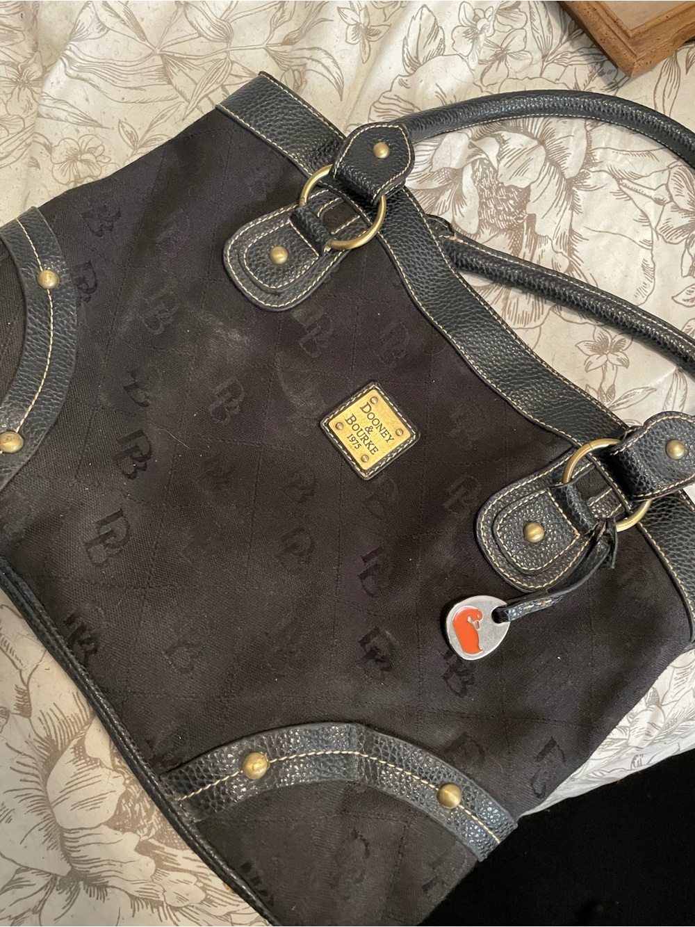Dooney & Bourke Black Tote with Gold Logo Plaque and Orange Charm